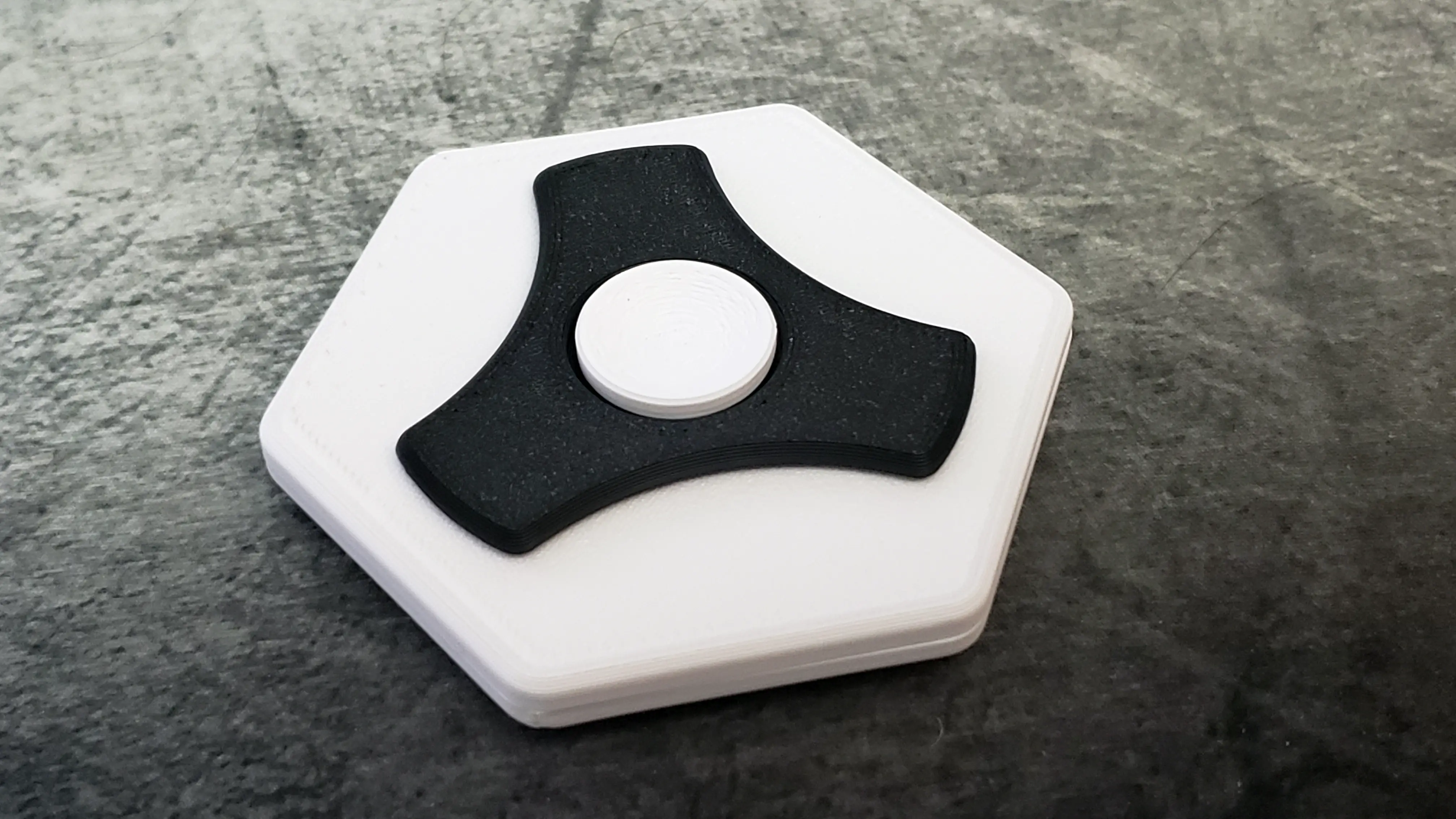 Deltaform Concentric Coin Spinner close-up showing the three independent sections
