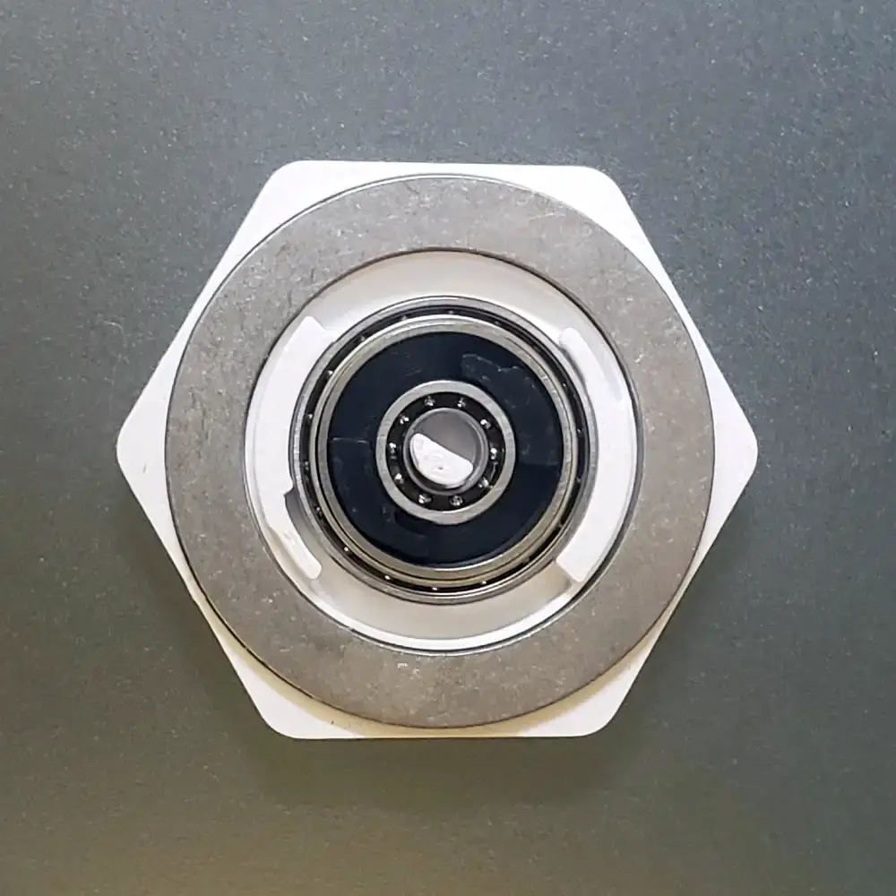 Concentric Coin Spinner with outer sections removed, showing the dual bearing system and metal mass ring